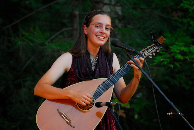 Laura playing lute bodied guitar